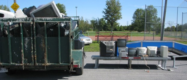 green bin filled with electronic waste