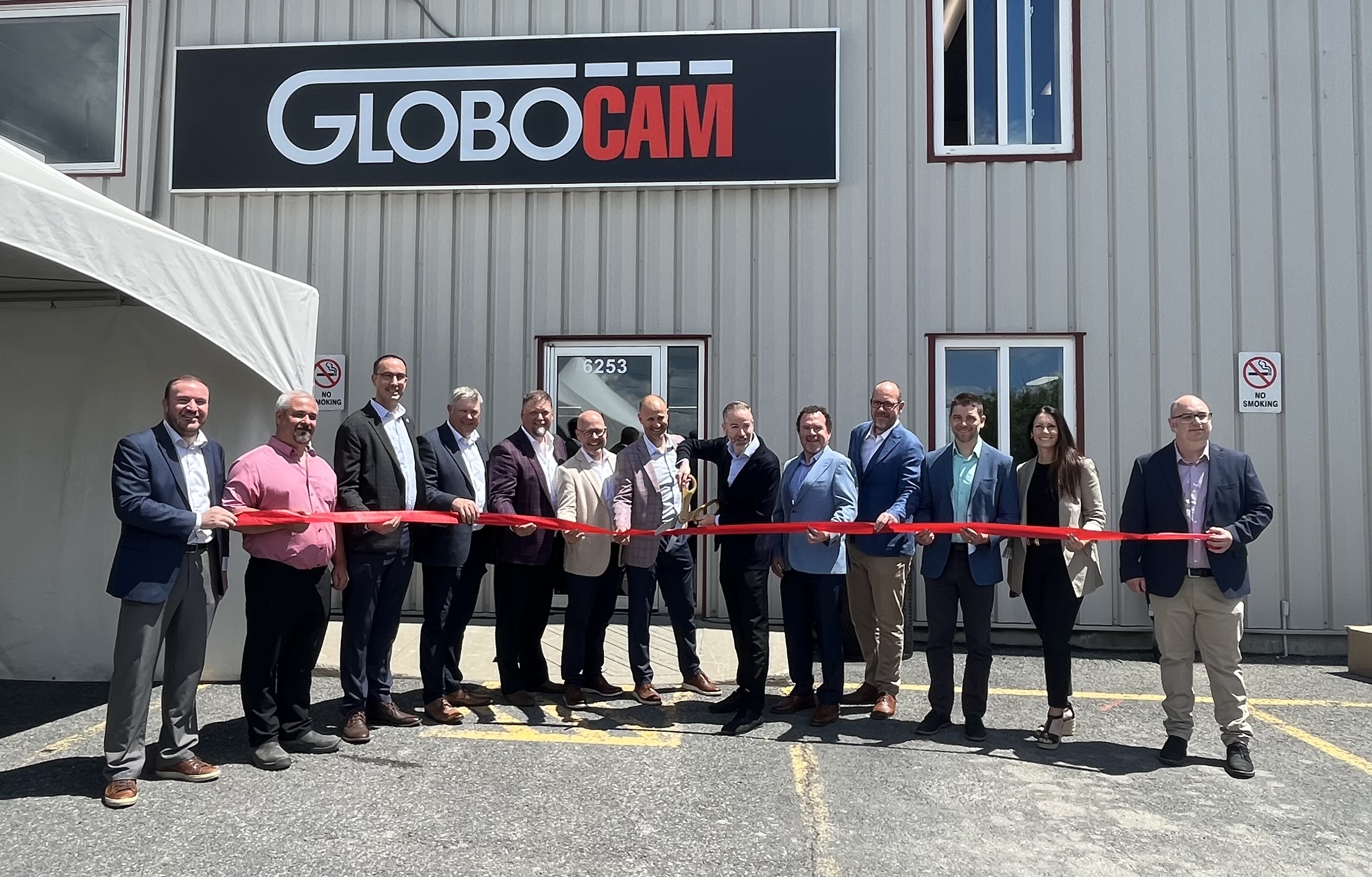 Group photo of ribbon cutting ceremony at Globocam Grand Opening